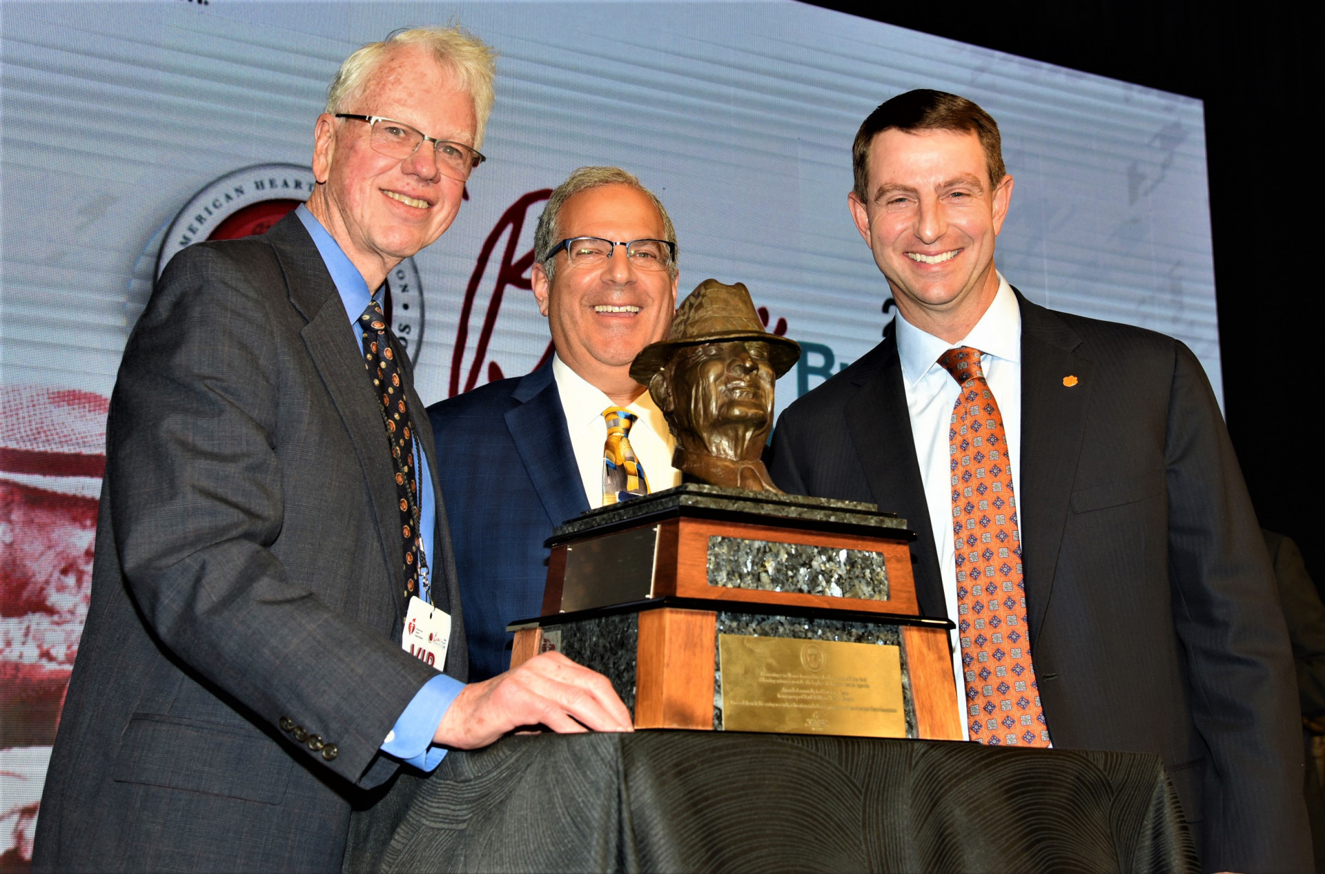 NSMA Board national chair Bob Ryan (left), NSMA executive director Dave Goren (center) and Clemson's Dabo Swinney pose with the Paul "Bear" Bryant Award