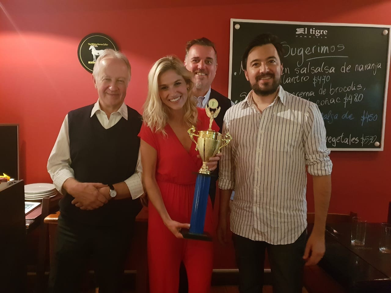 Erin Fish (in red), with her first place trophy for winning the AIPS Young Reporters Program contest (Photo provided by Erin Fish)