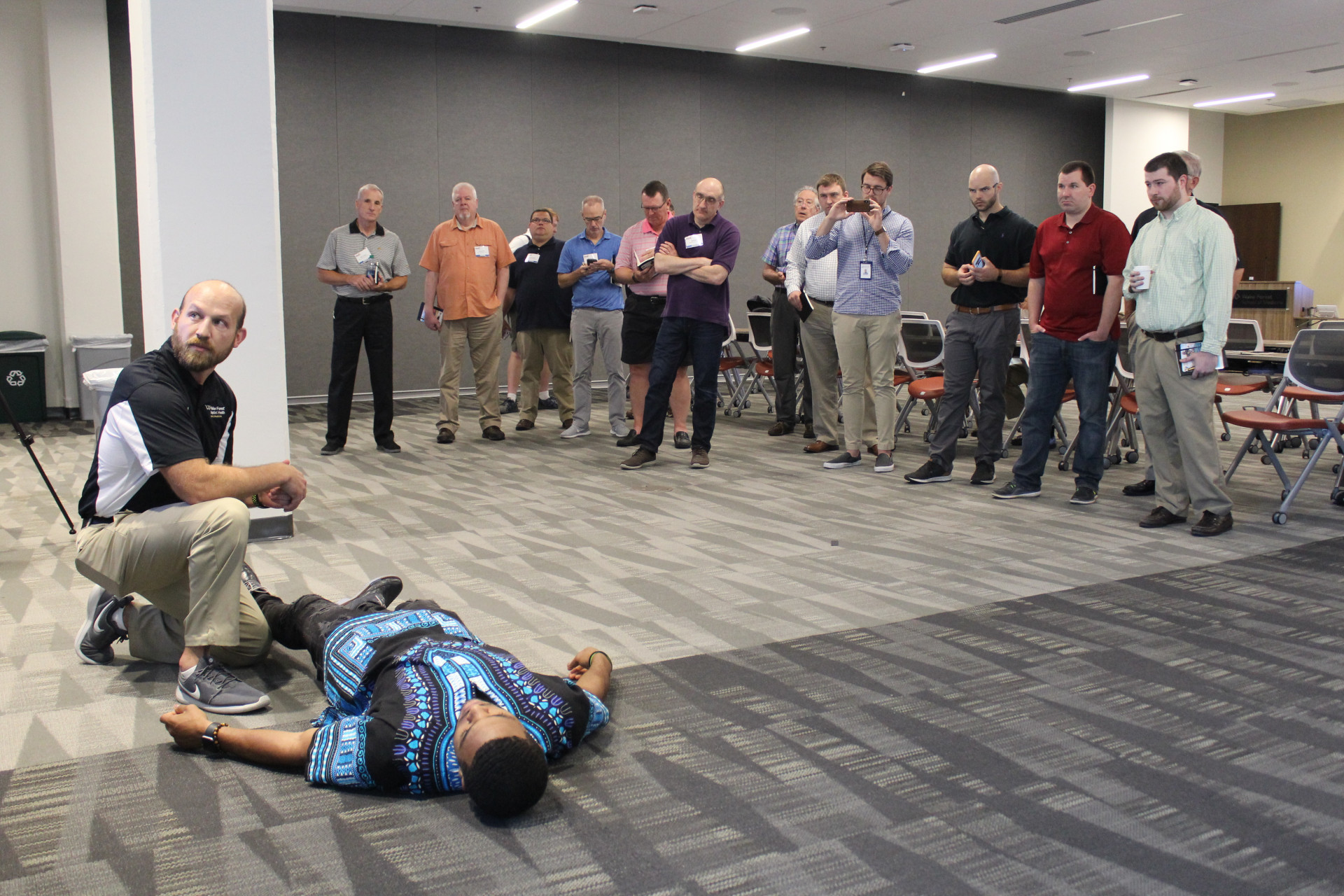 Wake Forest assistant athletic trainer Niles Fleet demonstrates protocol for knee injuries at the Sports Medicine Summit on June 24, 2018, at Wake Forest University School of Medicine