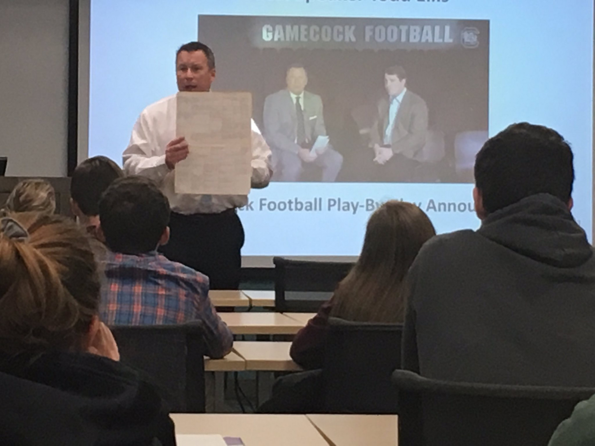 Todd Ellis shows examples of the tools he uses as USC's football play-by-play announcer